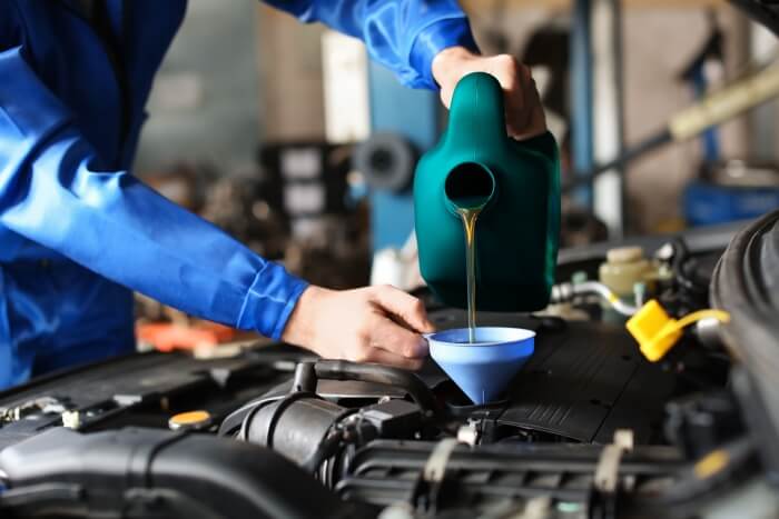 Refilling a car engine with motor oil