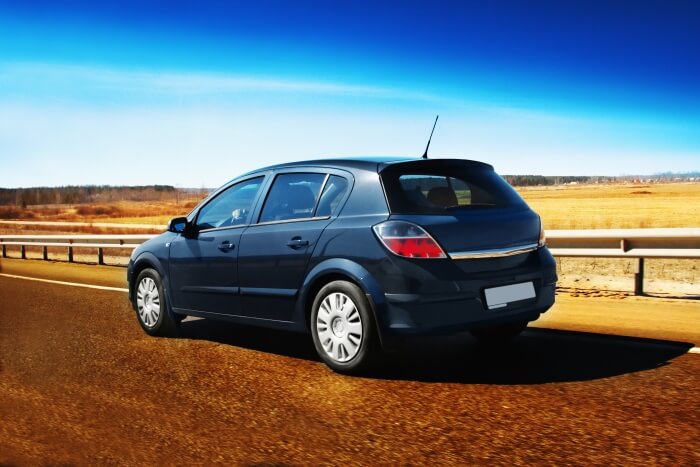 Opel Corsa on the road in the desert